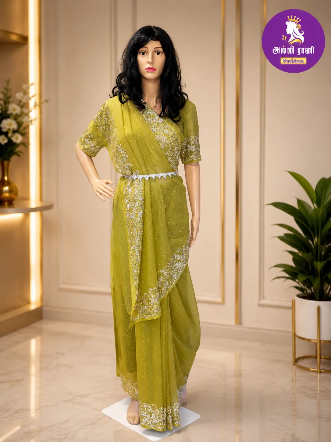 Olive chiffon saree draped on a mannequin with a fitted blouse