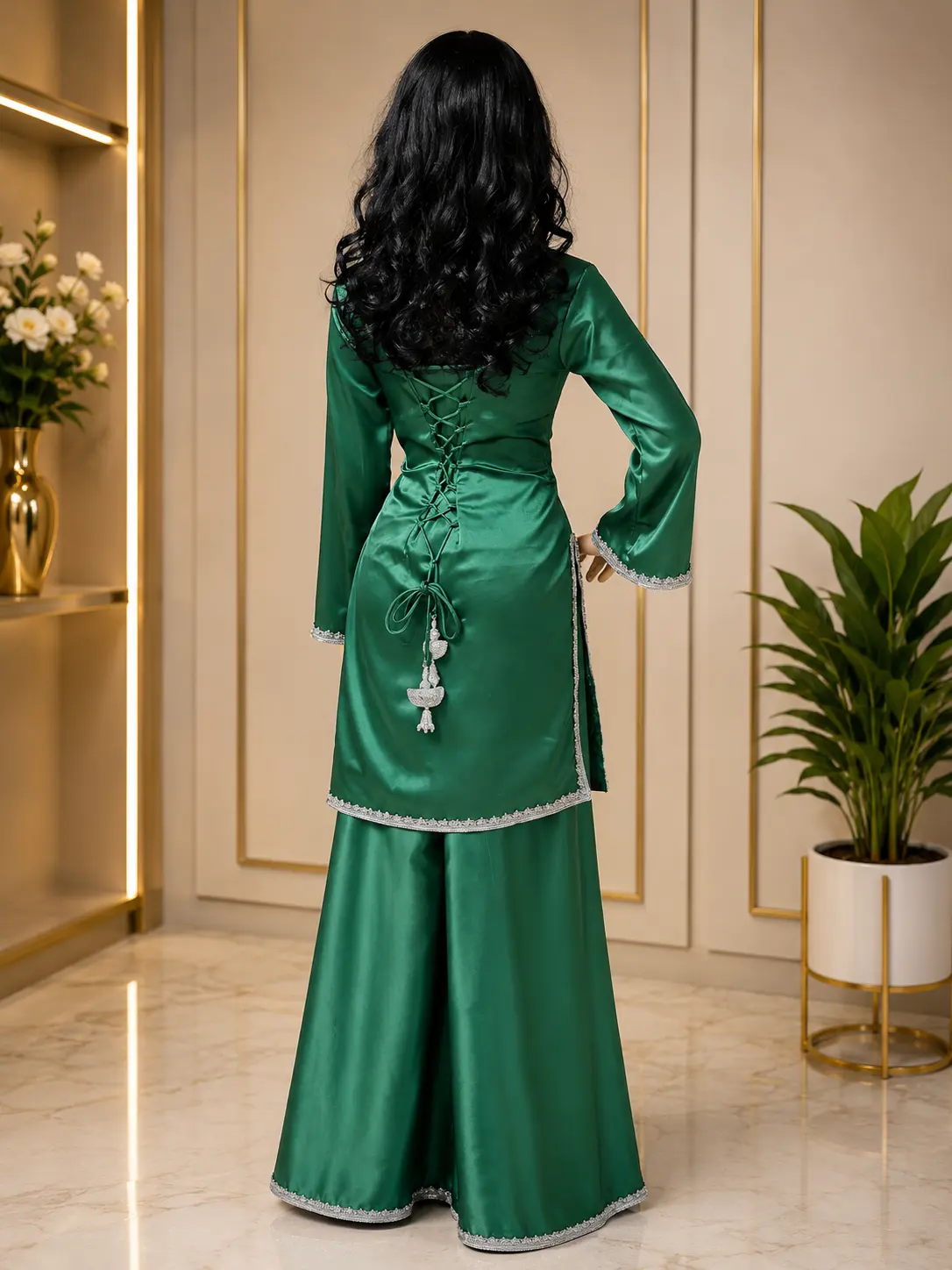 Rear view of an emerald satin sharara set stitched at the boutique